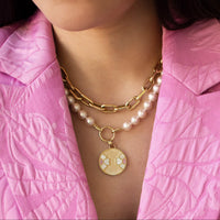 Woman wearing the 7-7.5mm Akoya Pearl Necklace with the Diptyph Floral Medallion and the Barbara Choker