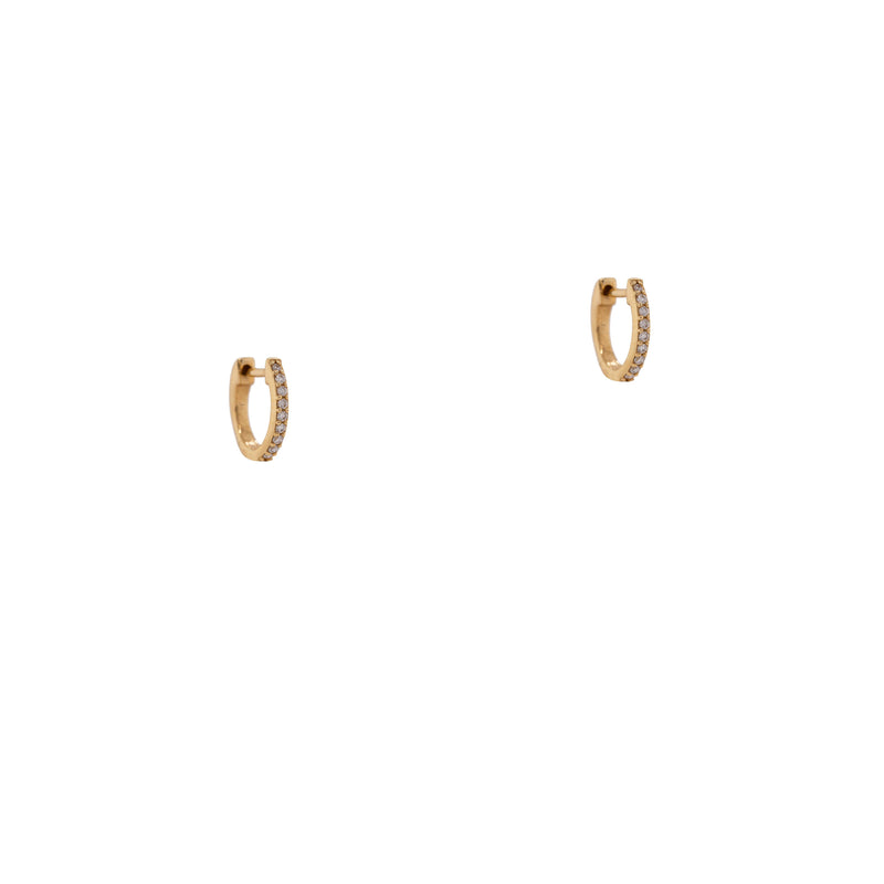 9mm Oval Diamond Huggies: 14K gold 9mm oval huggie earrings on a white background
