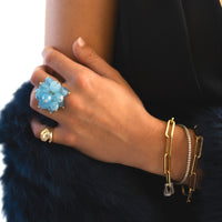 Hand wearing the Aquamarine Pom Pom Ring, 2mm Diamond Stretch Tennis Bracelet