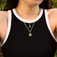 Woman wearing the Baby Hollow Diamond Star Necklace and the Starburst Diamond Necklace