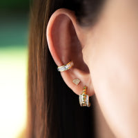 Close up of ear wearing the Baguette Ear Cuff, the Shield Studs, and the Double Prism Rock Huggies