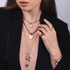 Woman wearing the Black Diamond Eclipse Necklace, the Black Diamond Shadow Necklace, Lovestruck Pendant, the Shadow Hollow Star Pendant, the Slanted Heart Ring, and the Double Chevon Ring