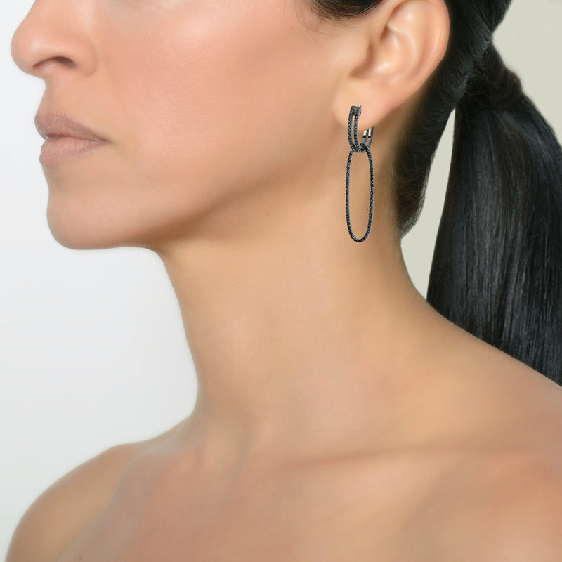 Black Spinel side of the Black Spinel Open Bar Huggies with Reversible White Sapphire & Black Spinel Oval Earring Extensions on a model