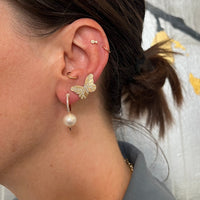 Close up of ear wearing the Butterfly Studs
