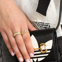 Hand wearing the Deco Status Ring and the Prism Rock Band