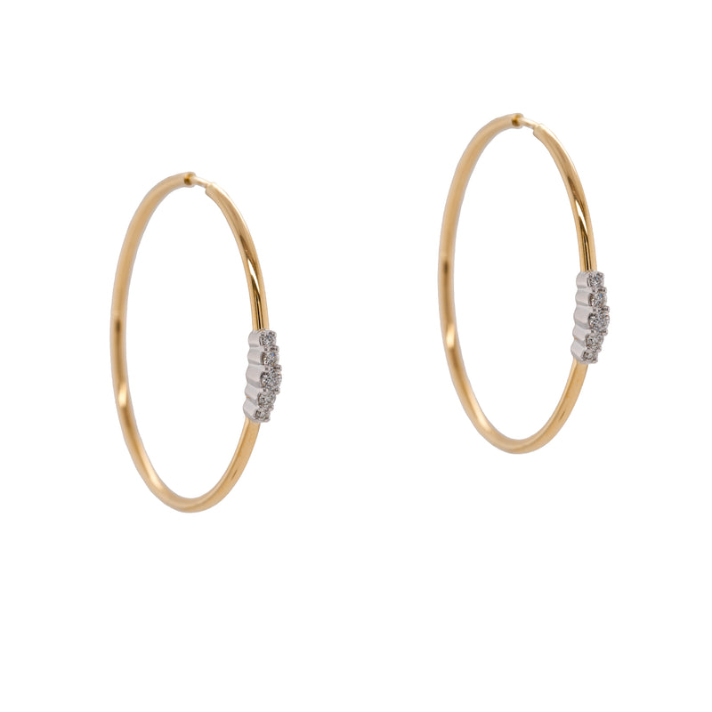 Diamond Cluster Hoops: a pair of 14K gold hoop earrings with diamond clusters, featuring an endless closure.
