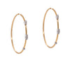 Diamond Endless Hoops: a pair of 14K gold hoop earrings with diamond clusters, featuring an endless closure.