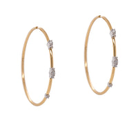 Diamond Endless Hoops: a pair of 14K gold hoop earrings with diamond clusters, featuring an endless closure.
