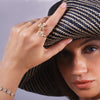 Woman wearing a wide-brimmed hat with the Diamond Floral Ring and Open Bar Diamond Rings
