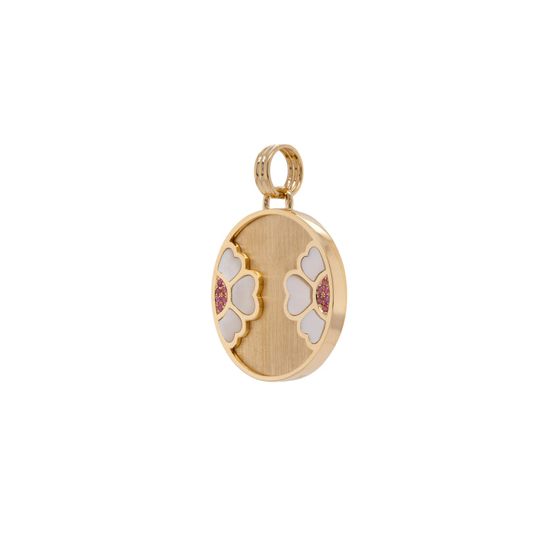 Diptyph Floral Medallion: 14K gold medallion with a flower design on a white background