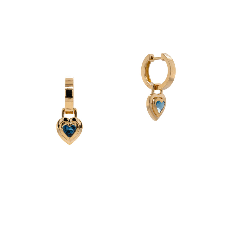 Double Bezel London Blue Topaz Heart Drops: A pair of 14K gold huggies with hinged hoops and London blue topaz heart-shaped drops.