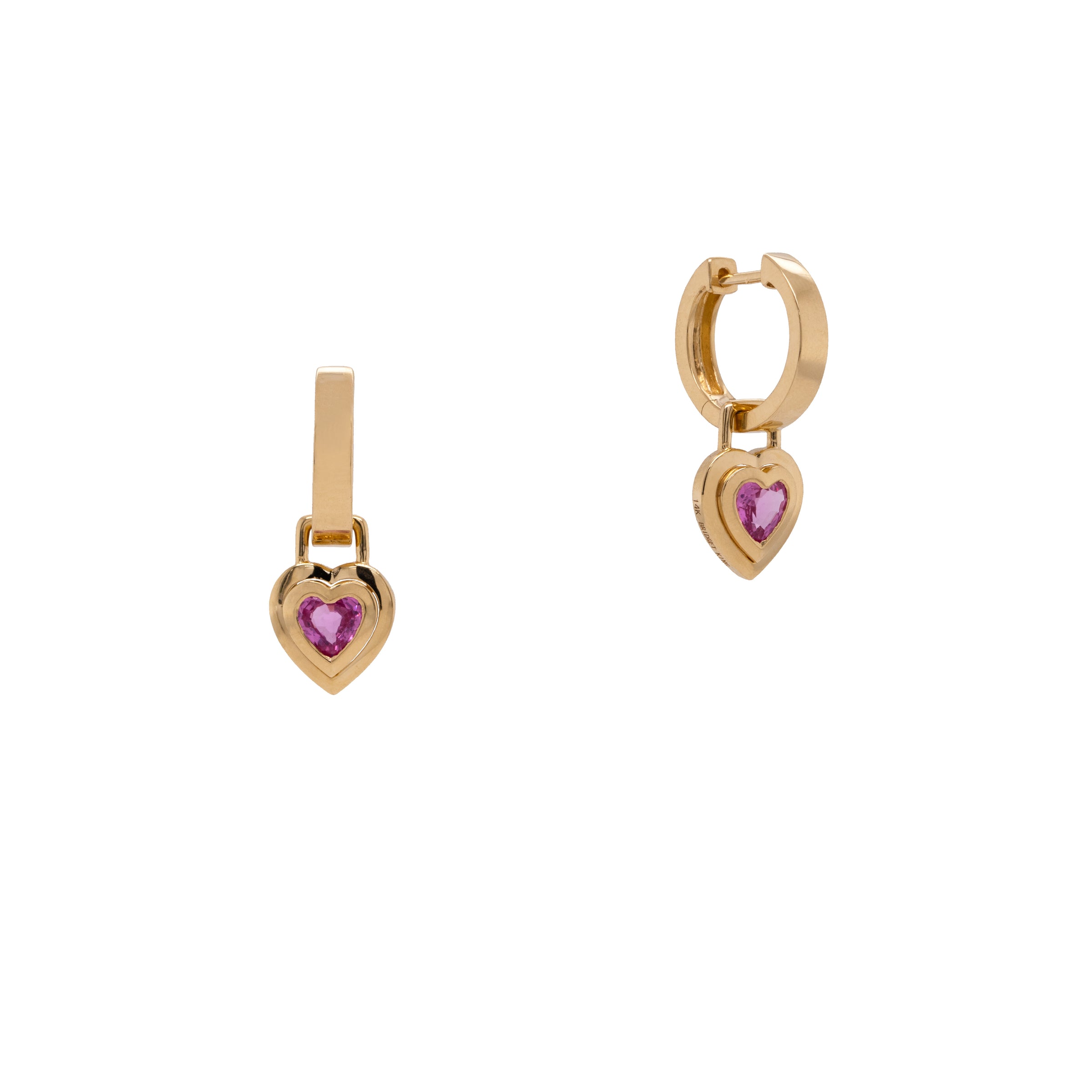 Double Bezel Pink Sapphire Heart Drops: A pair of 14K gold huggie earrings with heart-shaped pink sapphire drops attached.