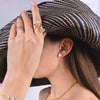 Person wearing the Eclipse Studs, with a straw hat.