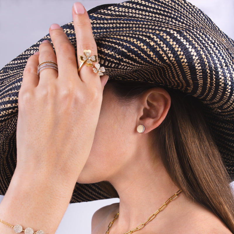 Person wearing the Eclipse Studs, with a straw hat.