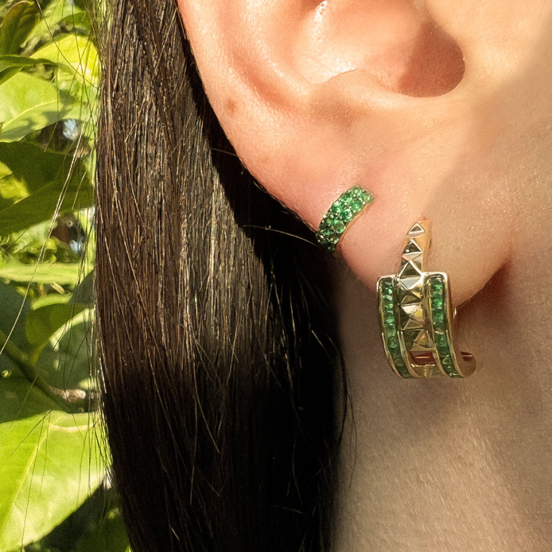 close up of ear wearing the Emerald Double Prism Rock Huggies