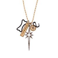 A 14K gold charm necklace with a long link chain and five charms: Engraved "B" Octagon Diamond Pendant, Engraved "Audrey" Double-Sided Dog Tag Pendant w/ White Diamonds, Large Starburst Spear, Large Hollow Black Diamond Dog Bone, Large Black Diamond Alphabet Pendant 