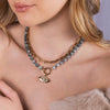 Close-up of a person wearing the Floral Evil Eye Eagle Eye Necklace and the Bone Link Chain