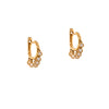 Fringe Huggies, 14K gold huggie earrings with small dangling diamonds on a white background