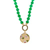 Garden Medallion Burmese Jade Necklace: A gold medallion with a floral garden pattern on a chain of green jade beads.