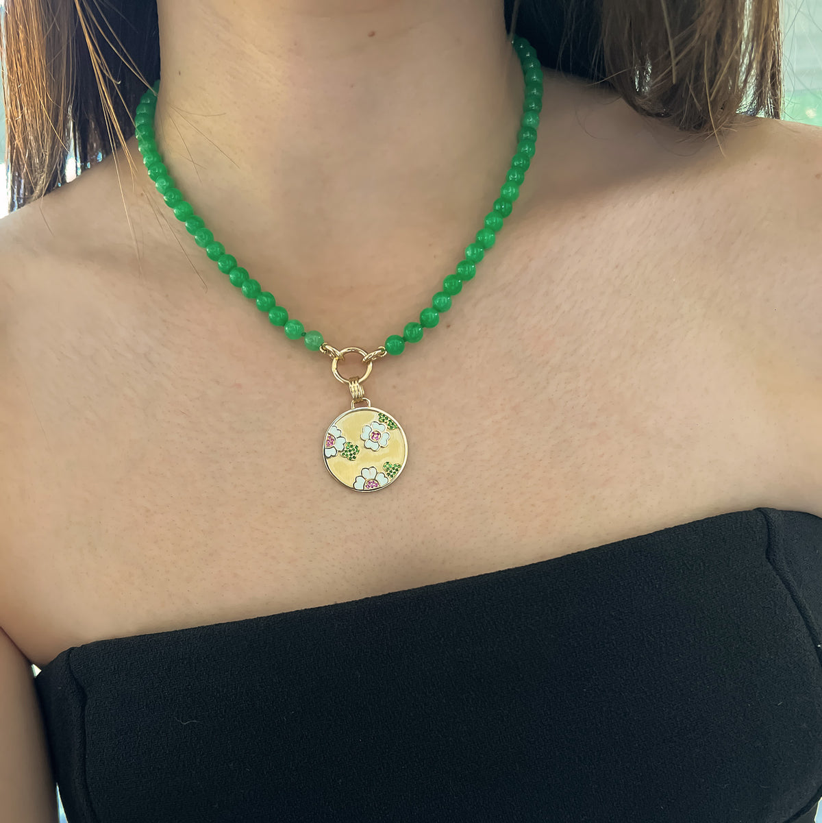 Close up of woman wearing the Garden Medallion Burmese Jade Necklace