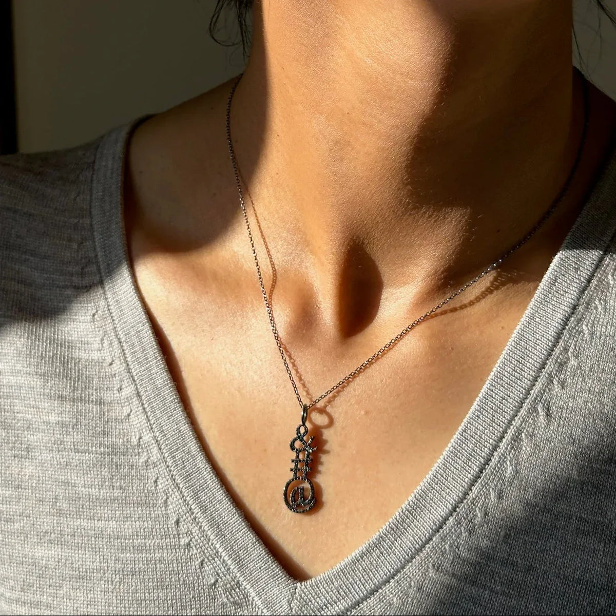 woman wearing the Silver Mini Link 16in-18in Adjustable Chain with Ampersand Pendant