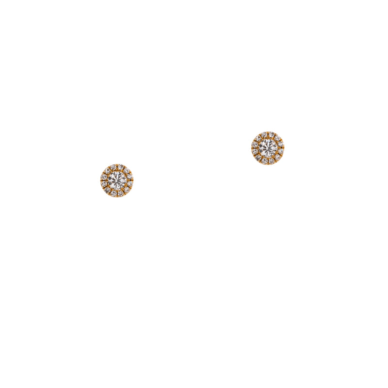 Illusion Round Studs: A pair of 14K gold round stud earrings with a central diamond and smaller surrounding diamonds.