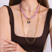 Woman wearing the Kunzite Necklace with the Bezel Spiral Heart Pendant, the Timeless Lariat, the Flora Ring, and the Liquid Vine Choker.
