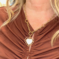 Woman wearing the Kylie Chain Necklace with the Mother-of-Pearl Halo Heart Pendant