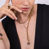 Close-up of a person wearing the Labradorite Sunburst Pendant with the Mixed-link Lariat, and the Chubby Diamond Cut Chain