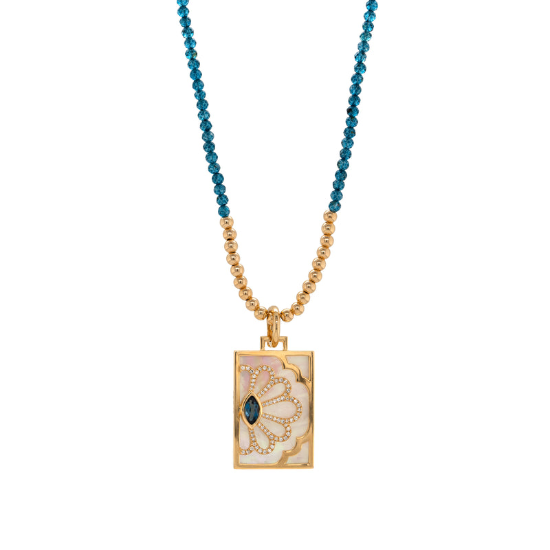  London Blue Topaz Floral Evil Eye Dog Tag, Necklace with blue beads and a gold dog tag pendant on a white background