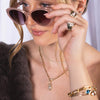 Woman wearing sunglasses, the Morganite Teardrop Pendant, and the Horsebit Link Diamond Necklace