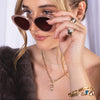 Woman wearing sunglasses, the Morganite Teardrop Pendant, and the Horsebit Link Diamond Necklace