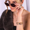 Woman wearing sunglasses, Morganite and London Blue Topaz Liquid Teardrop Bracelets, J Diamond Signet Ring, and Eternity Bracelet
