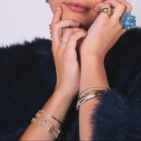 Close-up of hands wearing the Open Bar Tennis Bracelet, the Small Open Bar Tennis Bracelet, and the 24/7 Diamond Bracelet