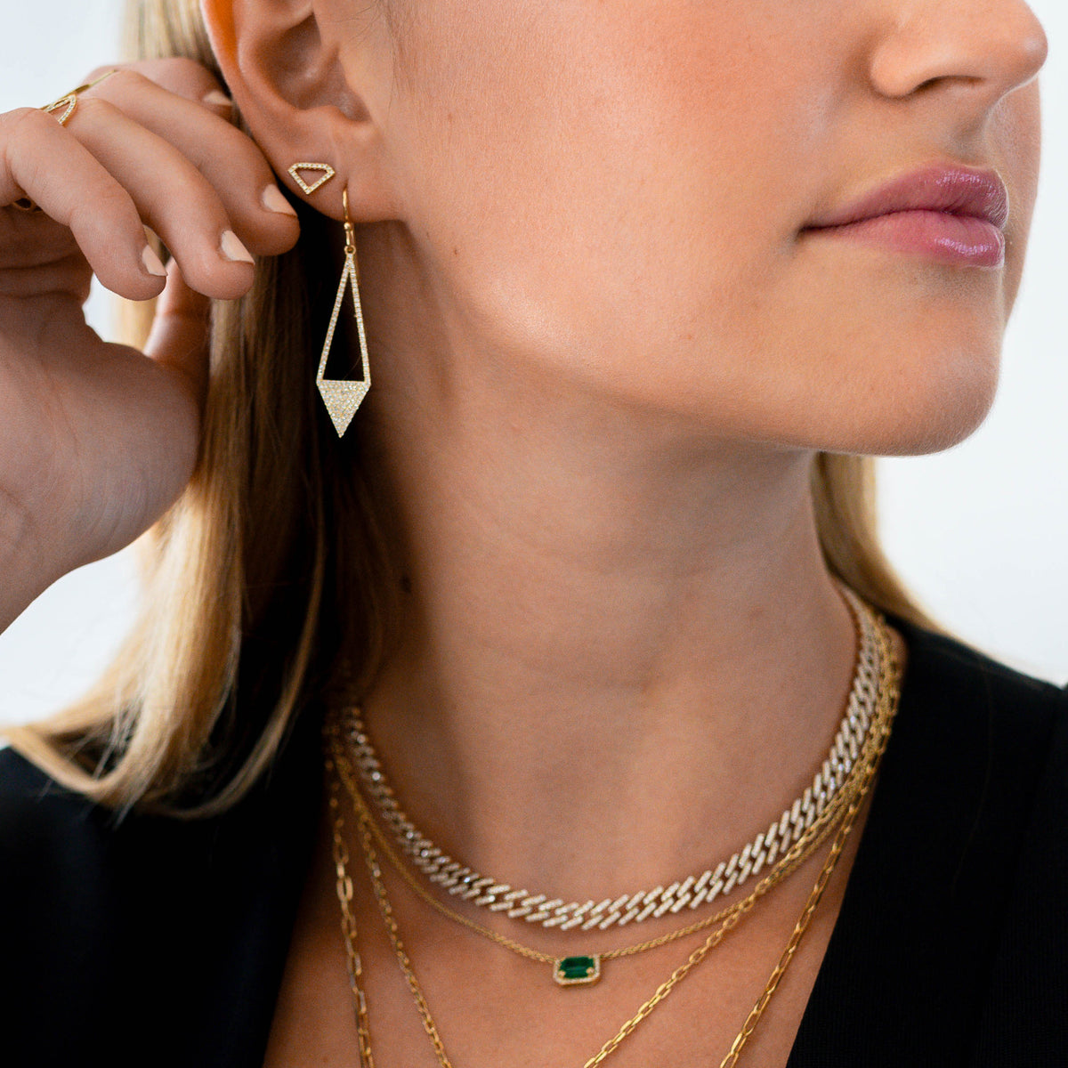 woman wearing the Open Shield Studs and the Diamond Arrow Earrings 