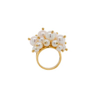 Pearl Pom Pom Ring: A gold ring with a cluster of white pearls on it, set against a white background.