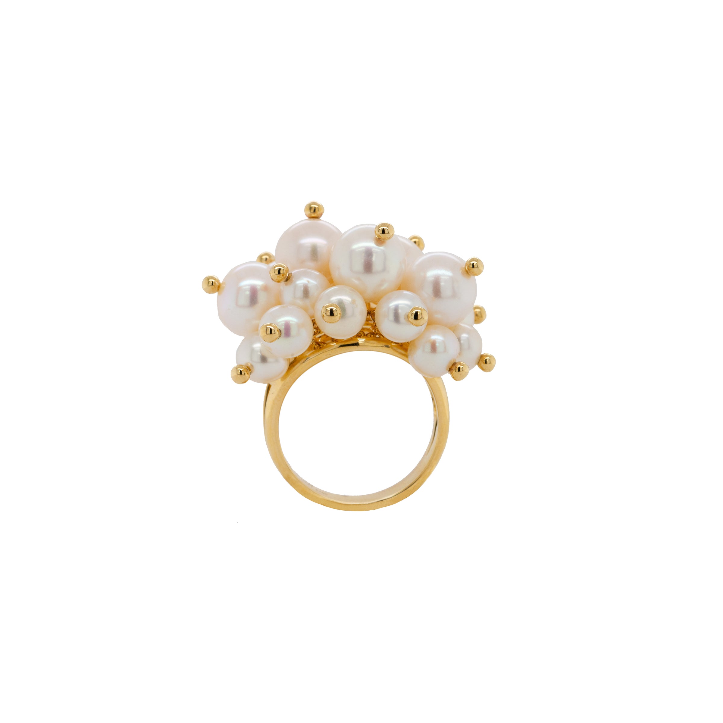 Pearl Pom Pom Ring: A gold ring with a cluster of white pearls on it, set against a white background.