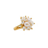 Pearl Pom Pom Ring: A gold ring with a cluster of white pearls on it, set against a white background.
