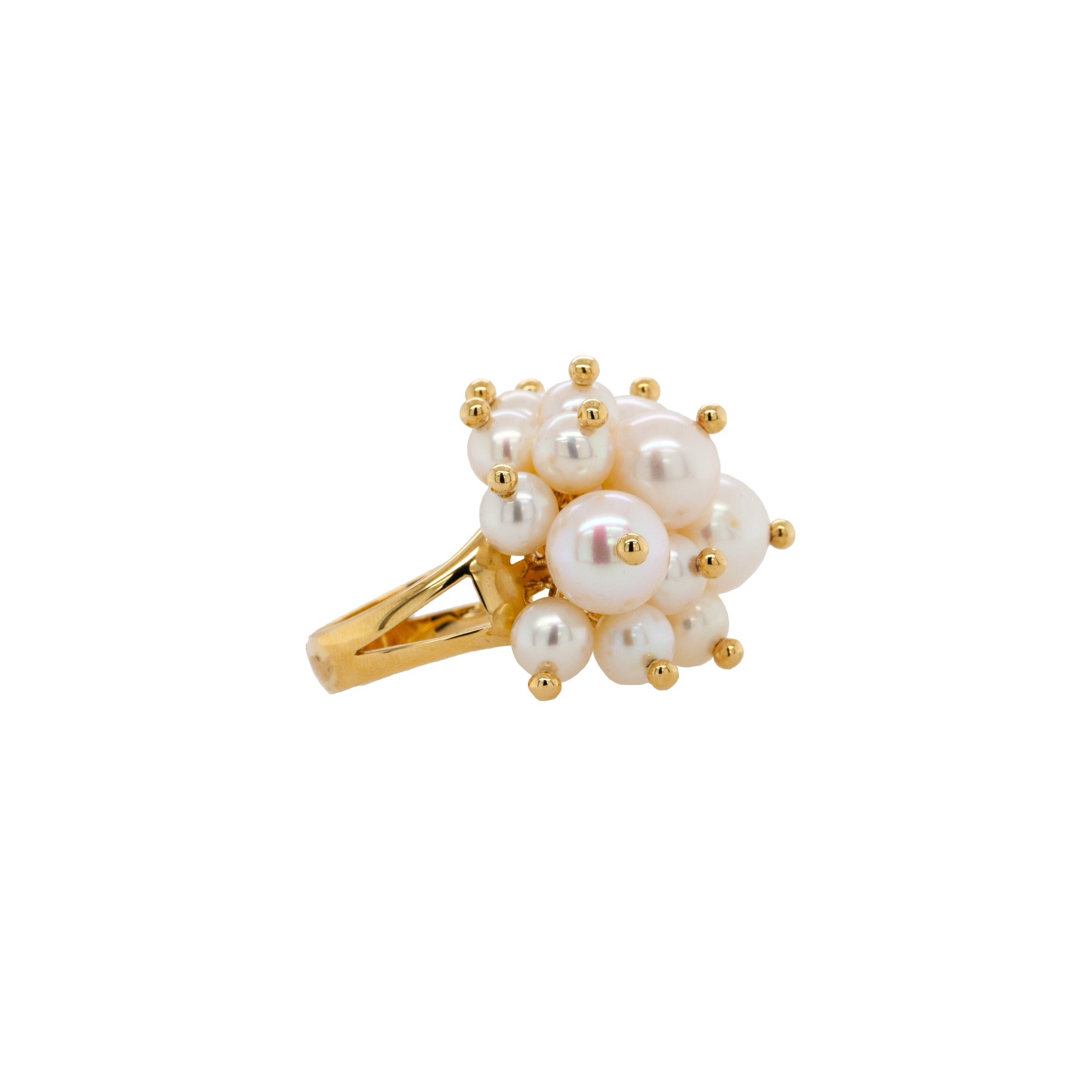 Pearl Pom Pom Ring: A gold ring with a cluster of white pearls on it, set against a white background.