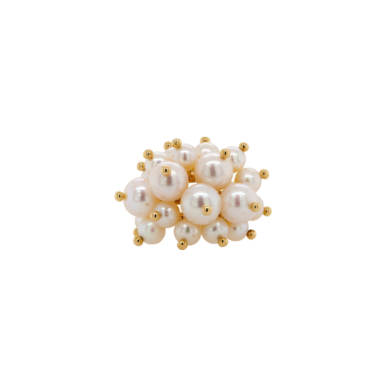 Pearl Pom Pom Ring: A gold ring with a cluster of white pearls on it, set against a white background.