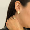Close up of woman wearing the Prism Clip Earrings, the "b" Alphabet Signet Ring