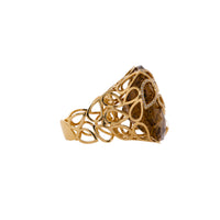 Rutilated Quartz Cocktail Ring: A 14K gold coctail ring featuring a large rutilated quartz centerpiece with a yellow band.