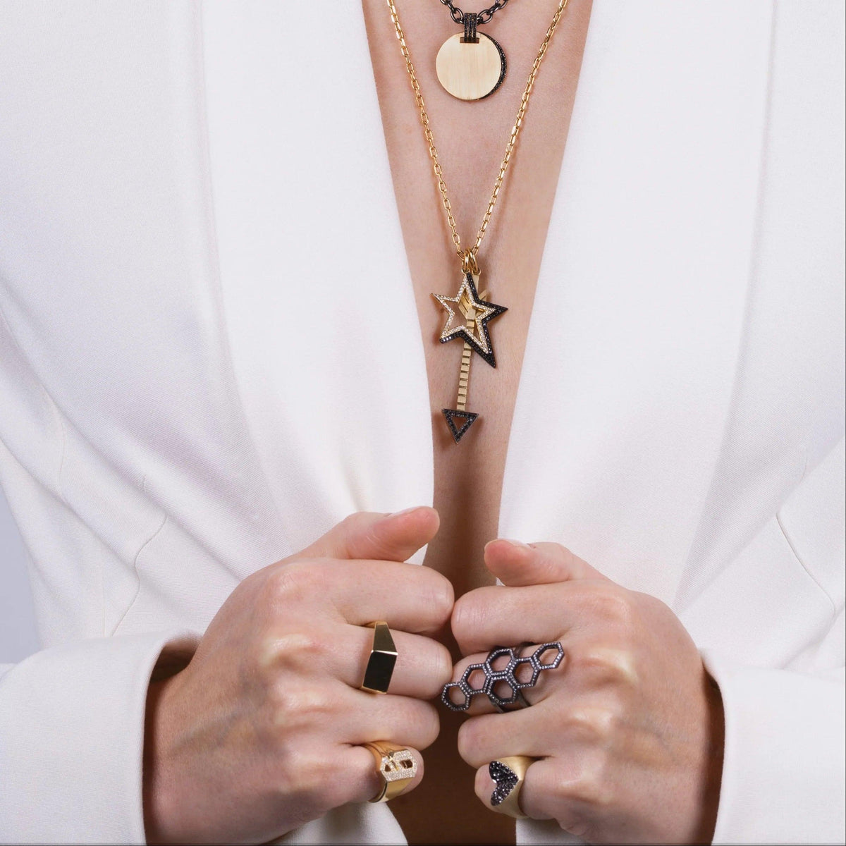 Woman wearing the Silver Queen Bee Ring, the Slanted Heart Ring, the Hexagon Diamond Ring, the Lovestruck and Shadow Hollow Diamond Star Charm Necklace