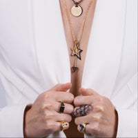 Woman wearing the Silver Queen Bee Ring, the Slanted Heart Ring, the Hexagon Diamond Ring, the Lovestruck and Shadow Hollow Diamond Star Charm Necklace