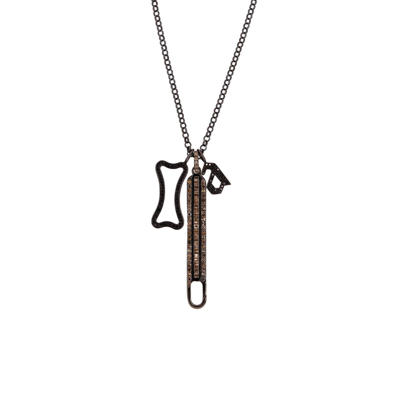 A silver charm necklace with a round link chain and three charms, including a Long Baguette Diamond Charm Clasp, a Small Black Diamond Alphabet Pendant, and a Small Hollow Black Diamond Dog Bone Pendant.