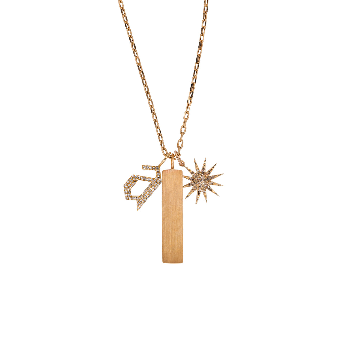 A 14K yellow gold charm necklace with three charms, including a starburst diamond pendant, a dog tag pendant, and a large diamond alphabet pendant.
