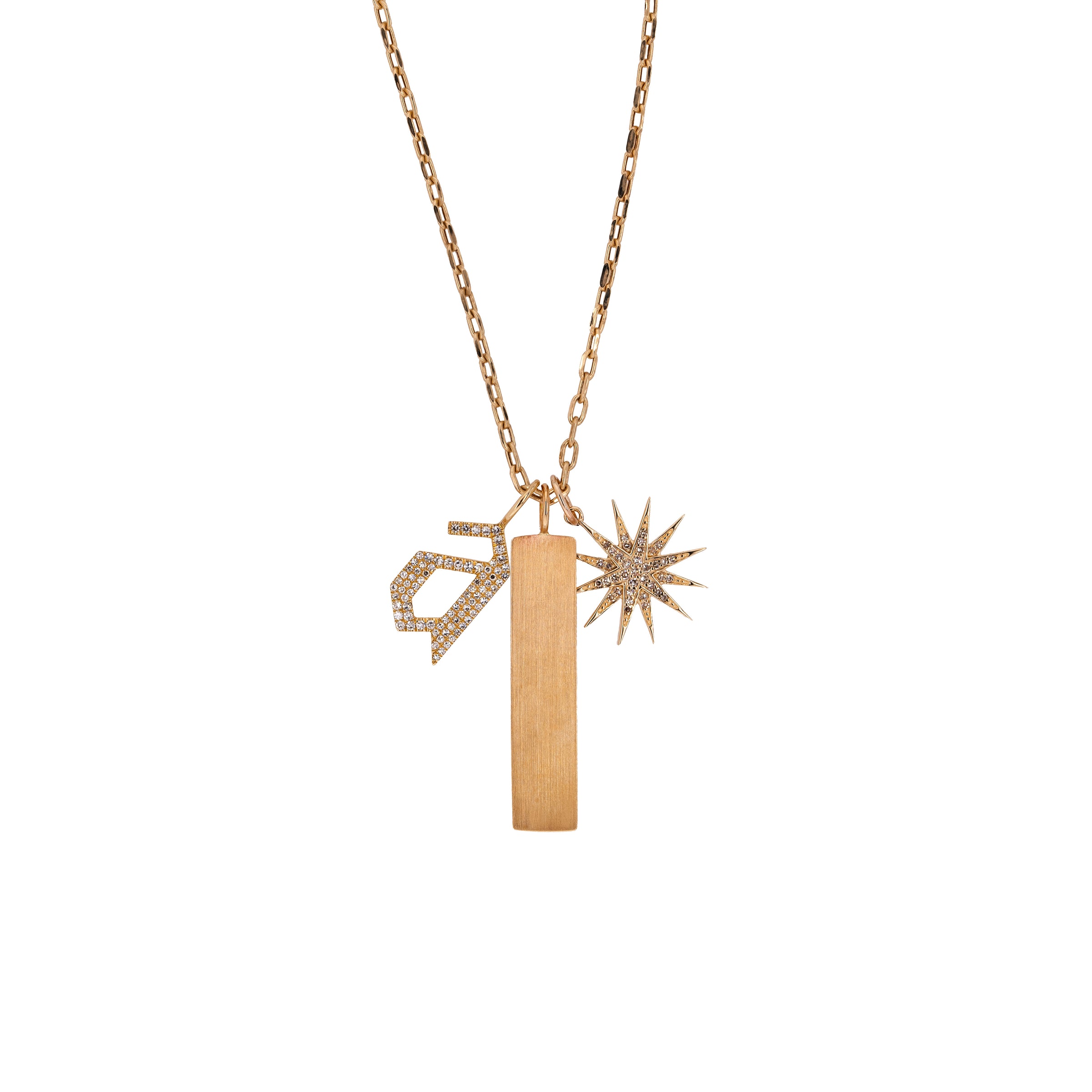A 14K yellow gold charm necklace with three charms, including a starburst diamond pendant, a dog tag pendant, and a large diamond alphabet pendant.