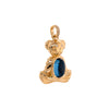 side view of 14K gold bear-shaped pendant, Teddy Pendant, featuring a London Blue Topaz gemstone on a white background