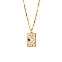 Tsavorite Floral Evil Eye Dog Tag, 14K Gold necklace with a pendant featuring a green gemstone on a white background