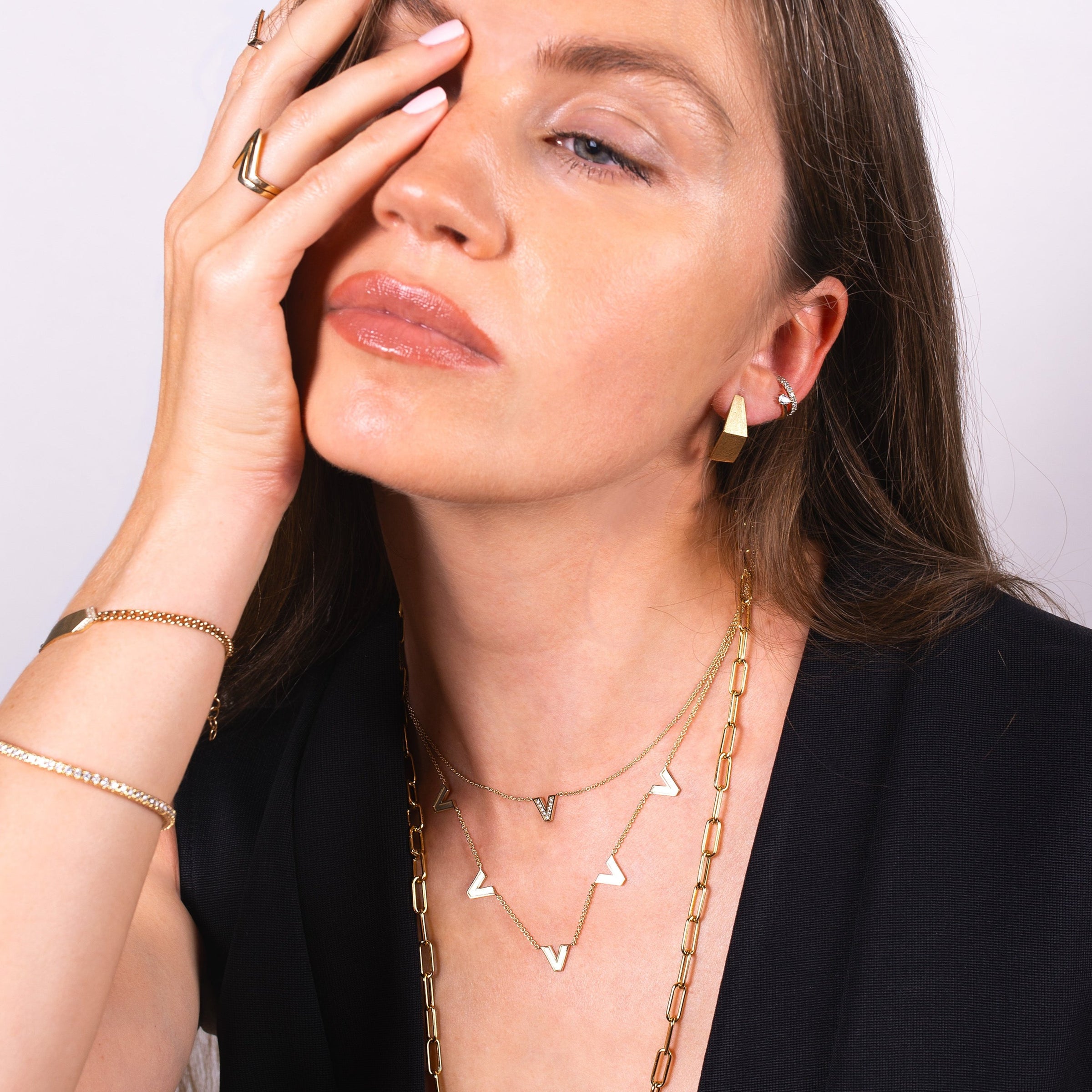 Women wearing the Venus Necklace, the Single Diamond Venus Necklace, the Fold-over Studs, and the Galaxy Ear Cuff